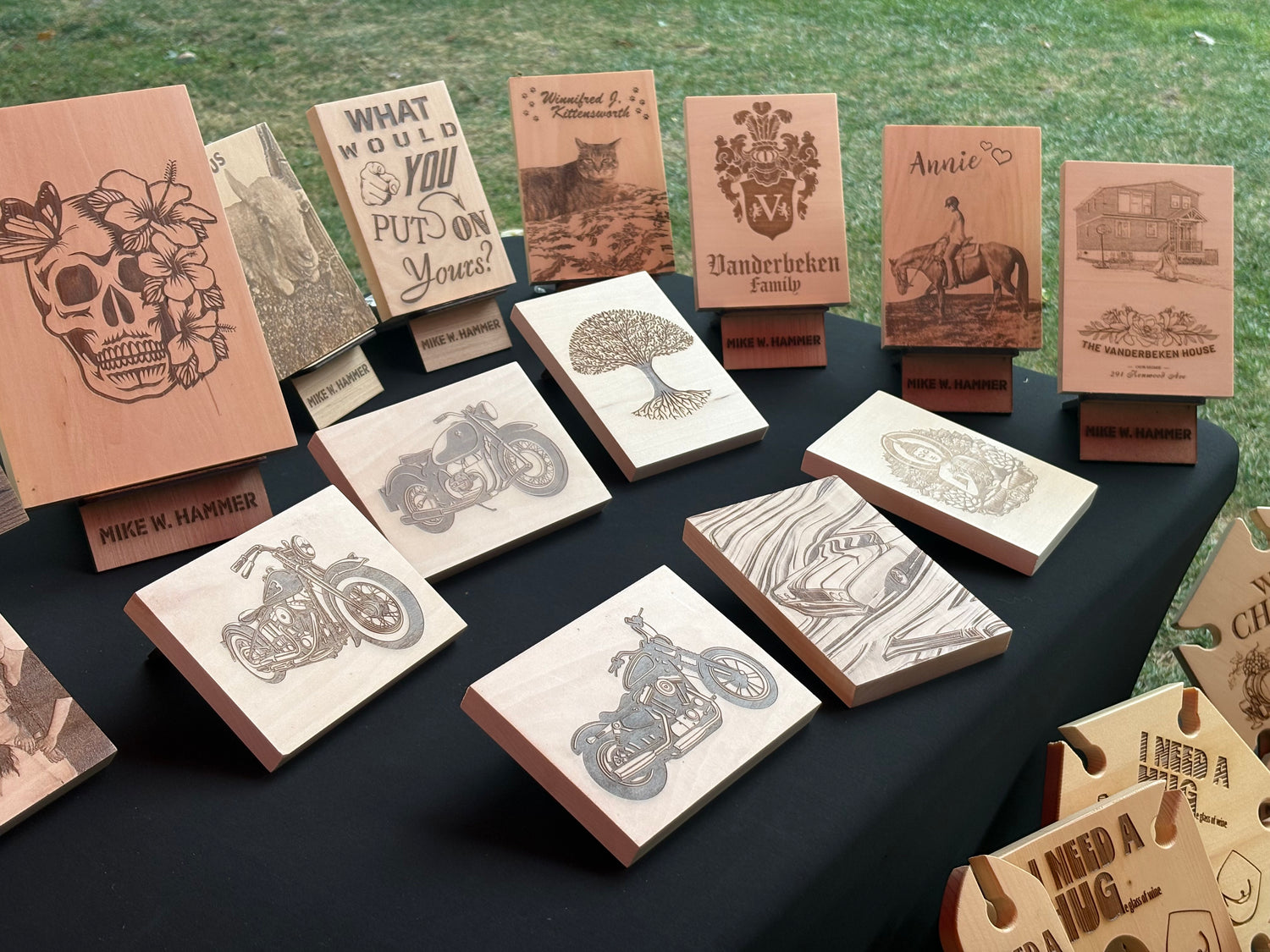 A collection of our wall art on a table, wooden blocks with various designs engraved on the surface.